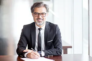 smiling-handsome-business-leader-making-notes